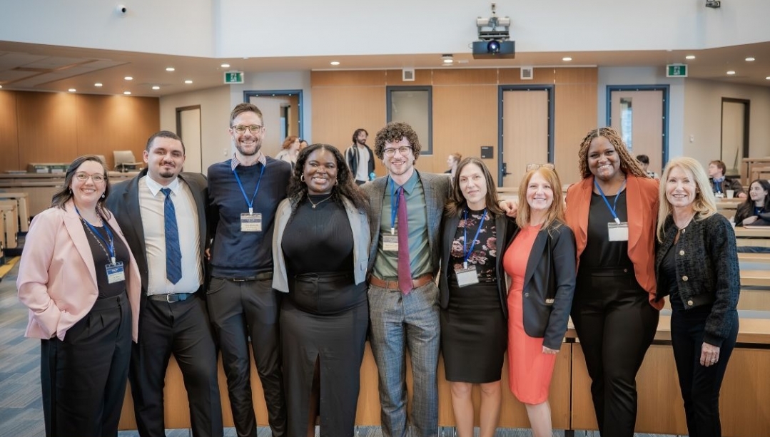 Organizers and panelists pose together in the moot courtoom on UWindsor campus