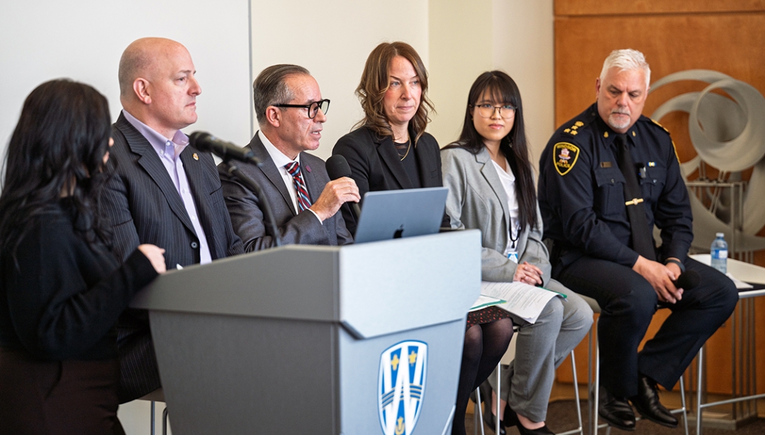 guest speakers seated speaking to audience