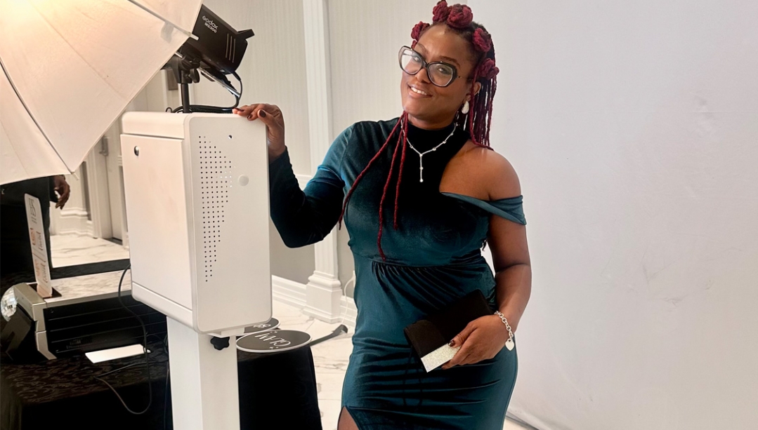 Teisha Gentles poses with her photo booth equipment.