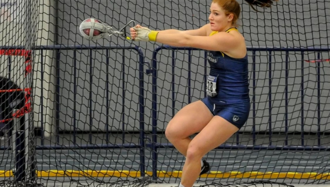 Sarah Mitton in Lancer jersey competing at shot put