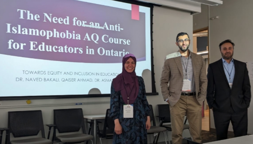 Asma Ahmed, Naved Bakali and Qaiser Ahmad in front of a projector screen with presentation slide about importance of AQ course