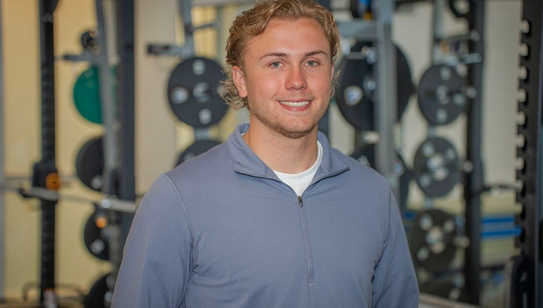 Brett Bjorgan in front of a rack of weights