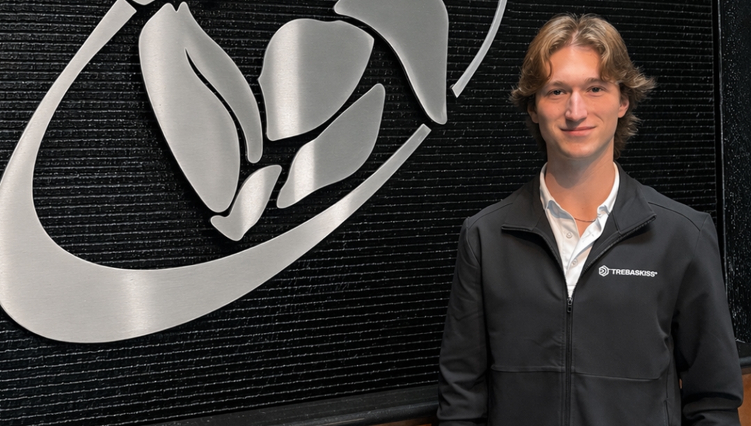 photo of Tyler Ballard standing next to the Tregaskiss logo