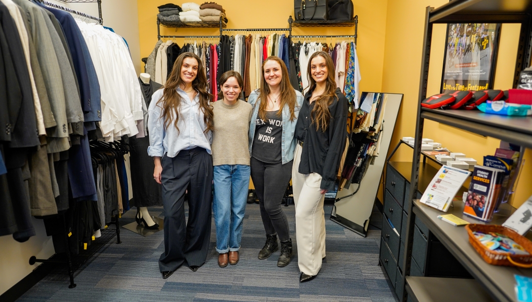 Founders of the Community Closet & Community Pantry stand in front of donated items