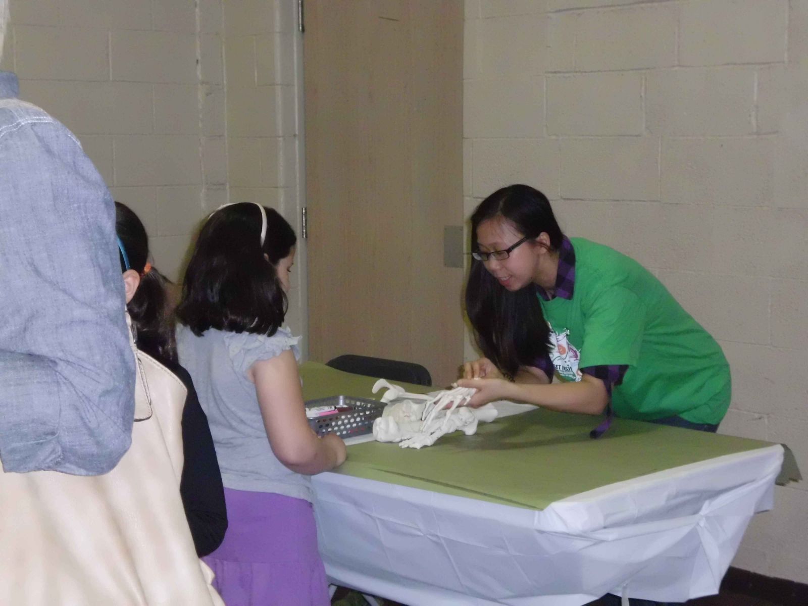 Volunteer Maggie showing attendees nursing activities