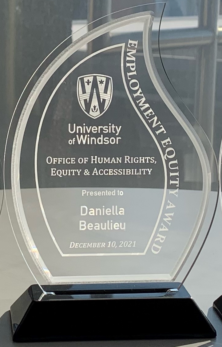 clear acrylic trophy presented to Daniella Beaulieu, Employment Equity Award