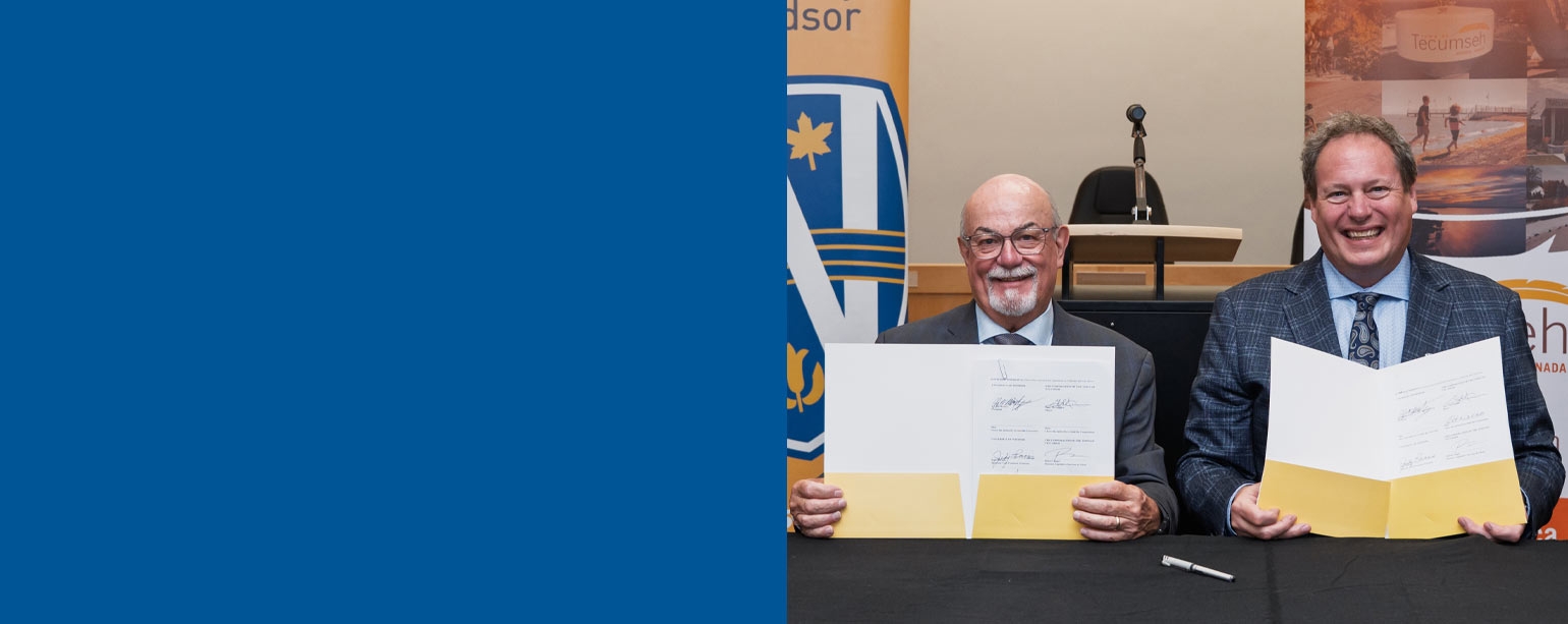 J.J. McMurtry and Gary McNamara hold signed documents