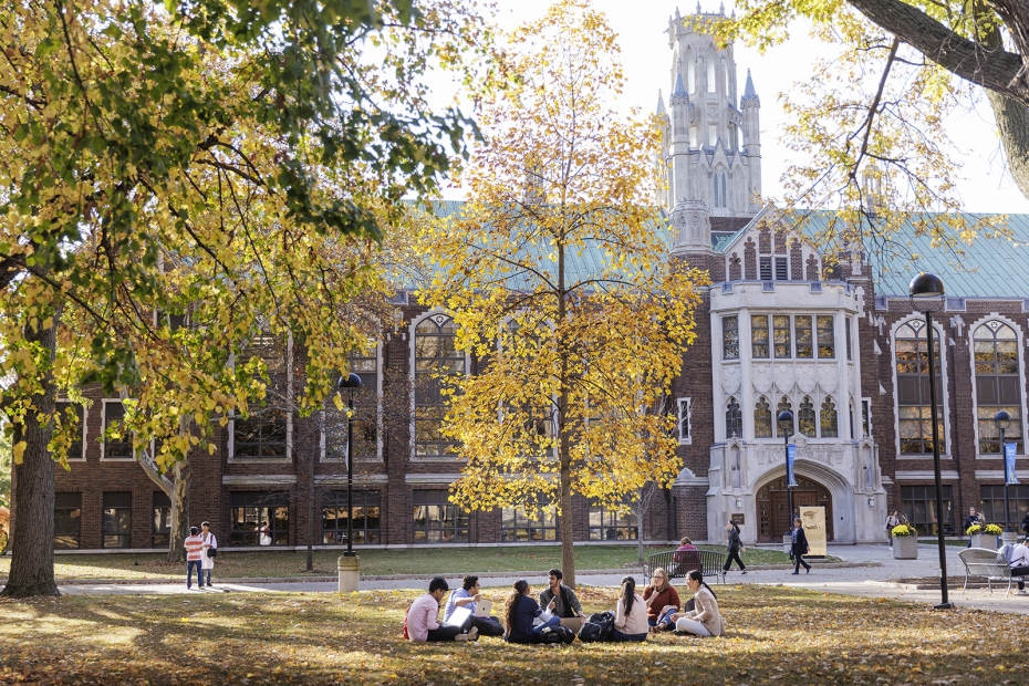 Students sit on the lawn outside of Dillon Hall.