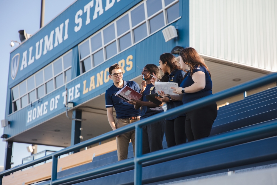 Students in the Master of Sport Management and Leadership program participate in a lesson at Alumni Stadium.