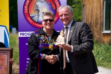 Jennifer D'Alimonte and Robert Gordon smile while shaking hands