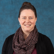 A woman with scarf smiles