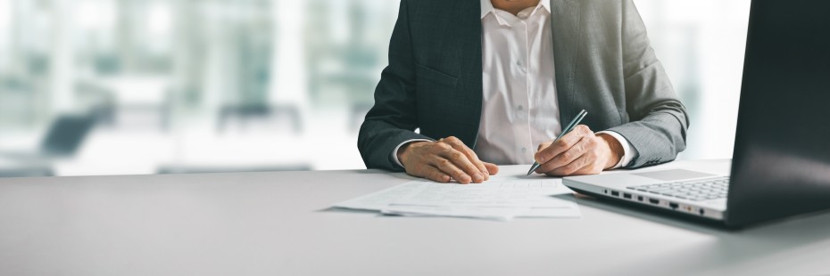 Man in a suit filing paper