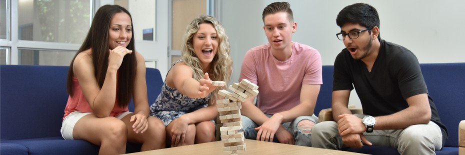 Four residence students playing a board game.