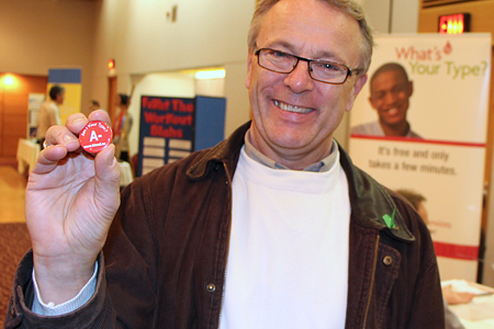 Lionel Walsh displaying a pin bearing slogan 