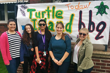 students alongside welcome banner