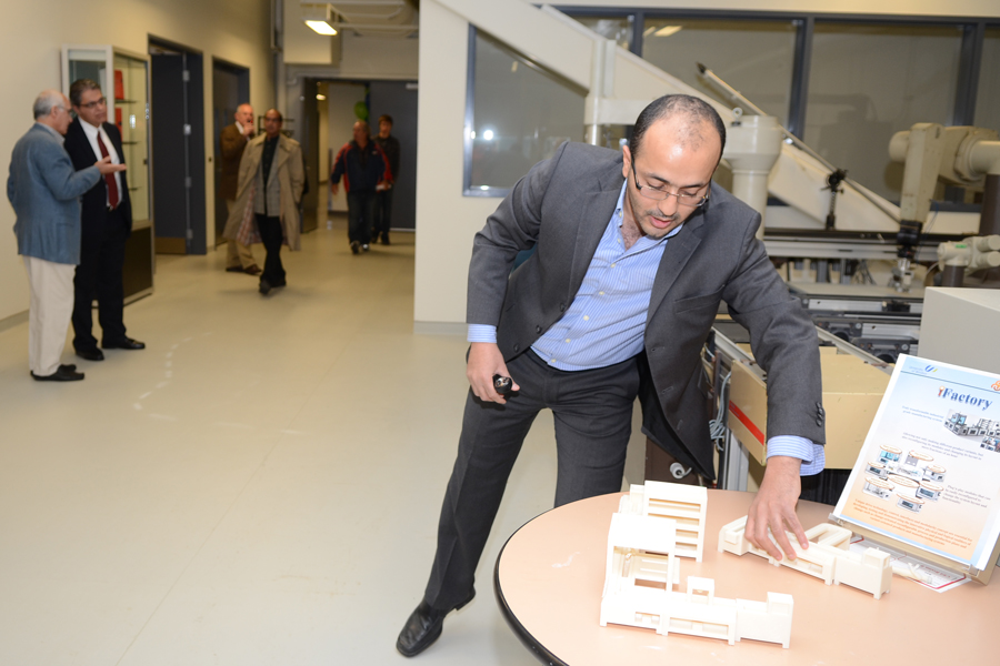 professor Ahmed Azab adjusts scale model on table