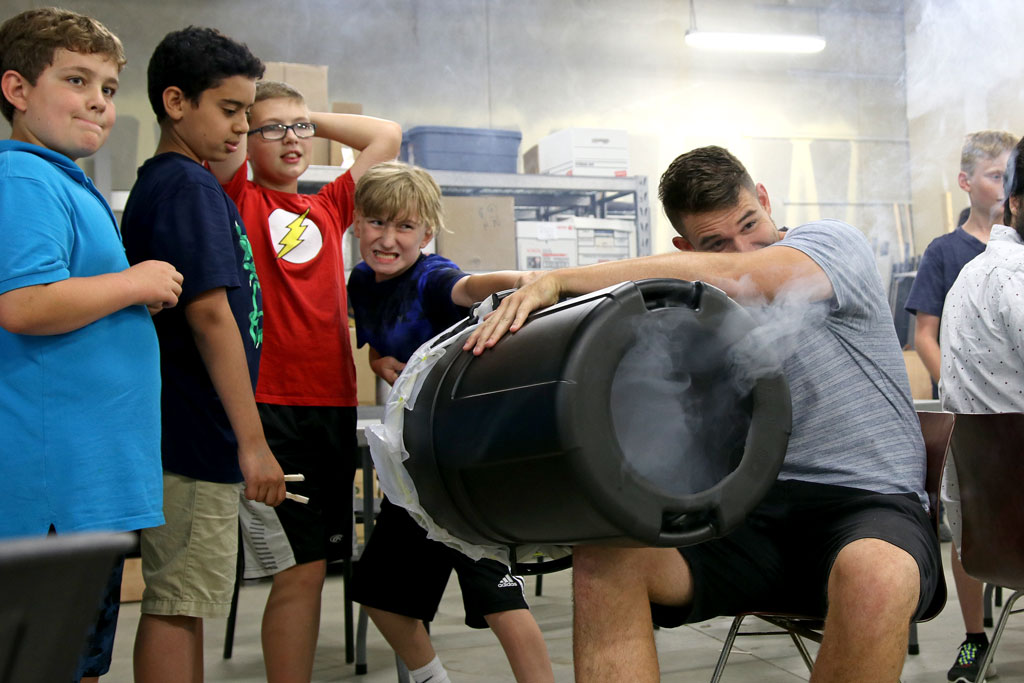A camper takes aim at a foam cup with an air cannon during the Lancer Engineering camp on Wednesday.