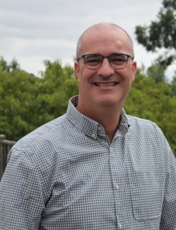 Man standing in nature smiling