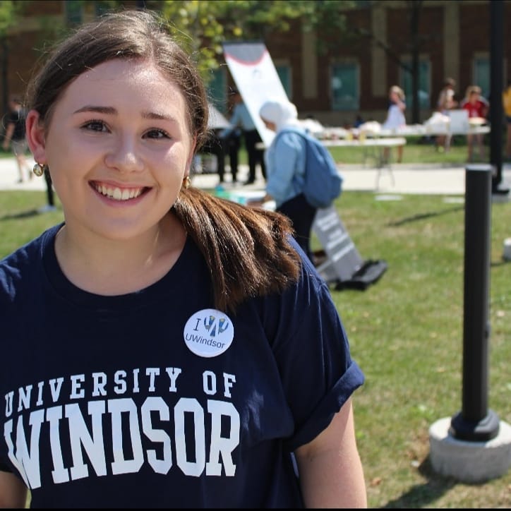 student with uwindsor shirt and spirit pin