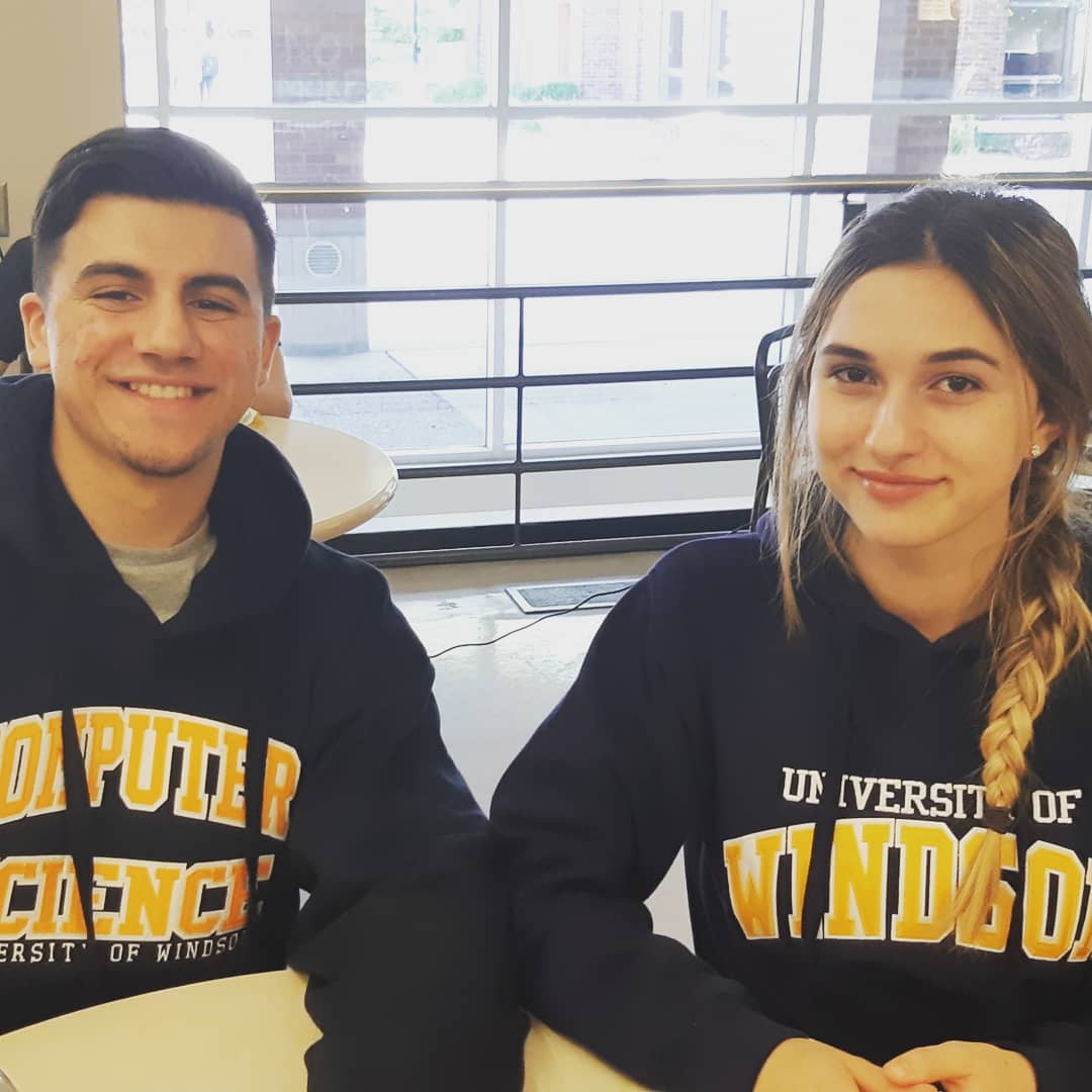 two students with UWin sweater