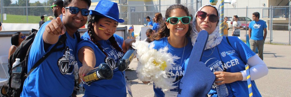 Four student volunteers in their Lancer gear showing spirit