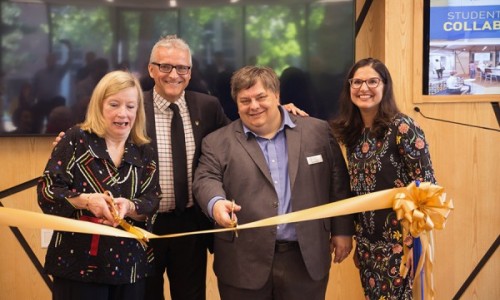 Donor Mary Hatch gets some help with ribbon cutting from UWindsor president Robert Gordon, head librarian Pascal Calarco, and associate Karen Pillon.