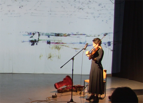 Anna Atkinson (visible) in performance with Brent Lee