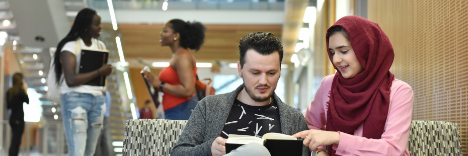 Two students studying on a couch