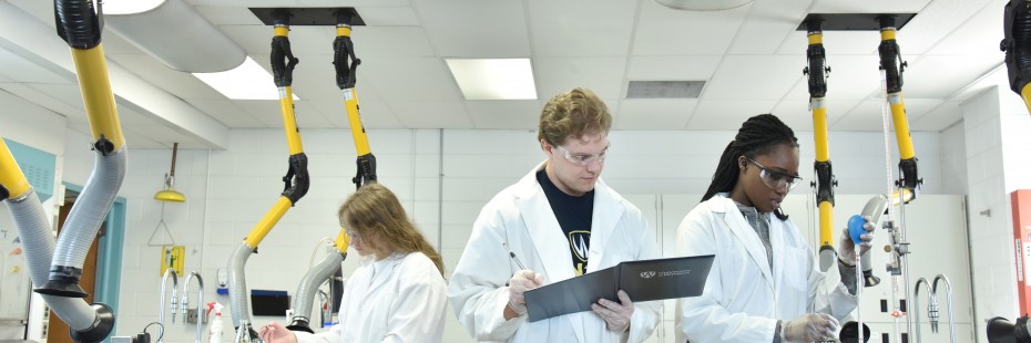 Three students working in a lab