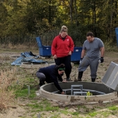 Watershed research technicians Mackenzie Porter and Samantha Dundas of the Essex Region Conservation Authority and biochemistry student Dave Ure clear a biofilter at the Lebo Creek Wetland.