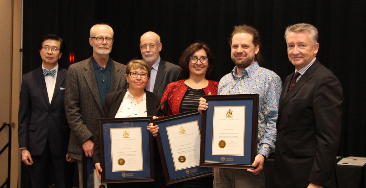 University officials congratulate winners of the UWindsor Award for Excellence in Scholarship, Research, and Creative Activity in the category of Established Scholars and Researchers: (from left) VP research and innovation K.W. Michael Siu, English professor Tom Dilworth, sociology professor Tanya Basok, acting provost Jeff Berryman, law professor Reem Bahdi, biology professor Dan Mennill, and interim president Douglas Kneale.