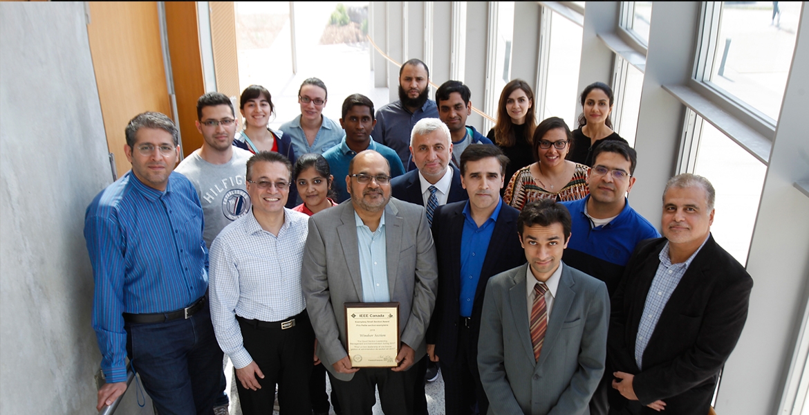 Engineering professor Mohammed Khalid, pictured centre with members of the IEEE Windsor Section, displays an award the group received under his leadership. Khalid has been elected to the executive committee of the Institute of Electrical and Electronics Engineers (IEEE) Canada.