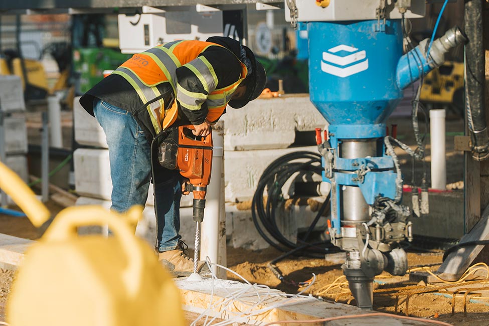Ground level view of construction worker and printing head nearby