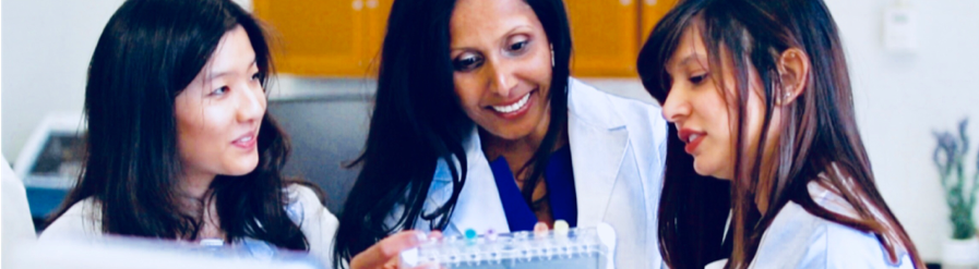 Faculty and students in lab coats