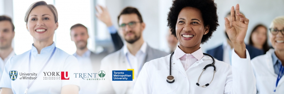 Internationally educated nurse raising hand and smiling in a classroom