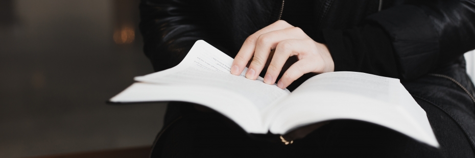 A person reading a book on their lap.