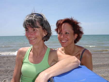Head and shoulder shot of Marie-Jeanne Monette and Marianne Poumay with beach behind them.