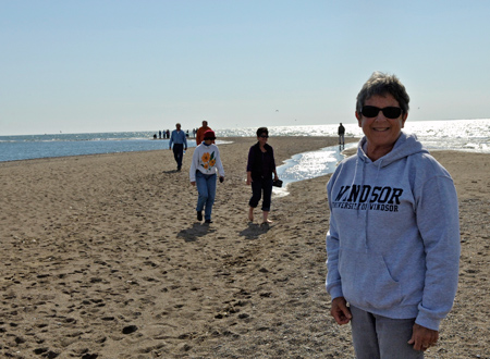 Sue Purnell stands on an elevated platform with Point Pelee National Park marsh in the background.