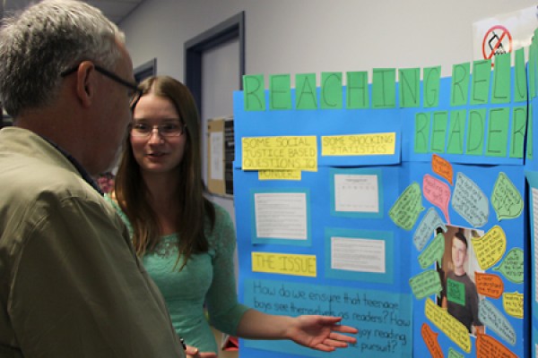 Education student Sarah McGuire explains her project during Friday’s poster exhibit.