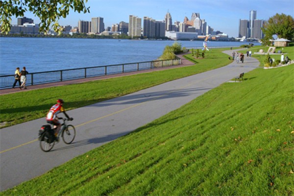 cyclist riding along riverfront trail
