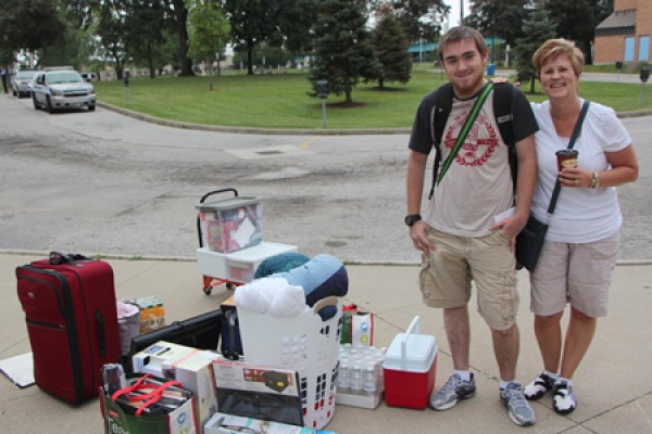 Brendan Burger and his mother Michele with piles of luggage