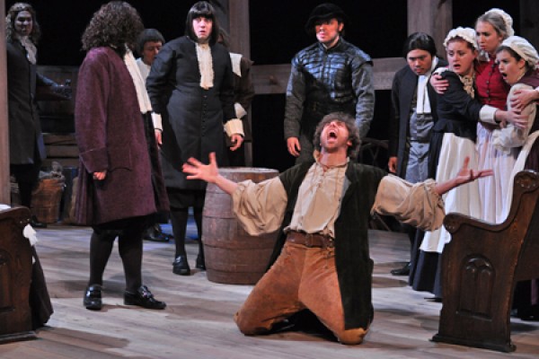 John Proctor (Mauro Meo) takes to his knees