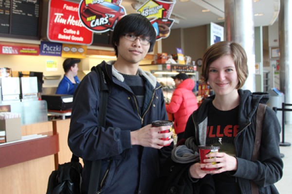 students hold coffee at Tim Hortons kiosk