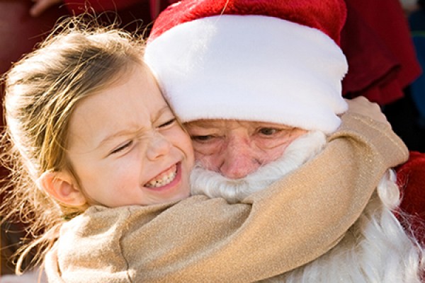 young girl hugging Santa