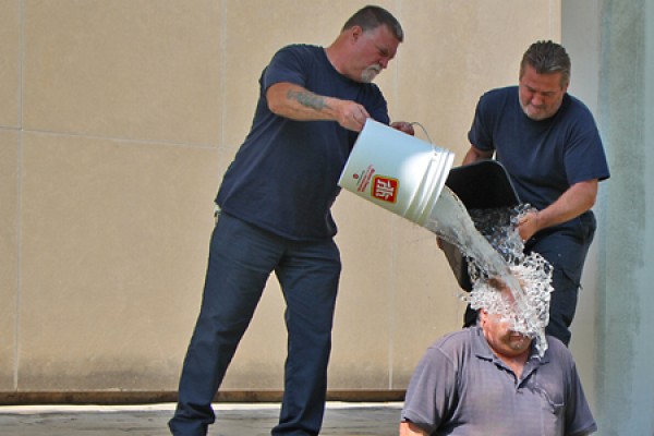 Housekeepers Tom Dean and Colin Bateman pour buckets of ice water over co-worker Mark Spearing