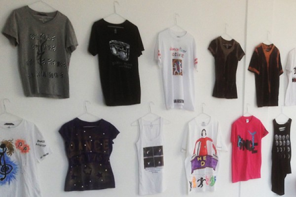 T-shirts on hangers against gallery wall