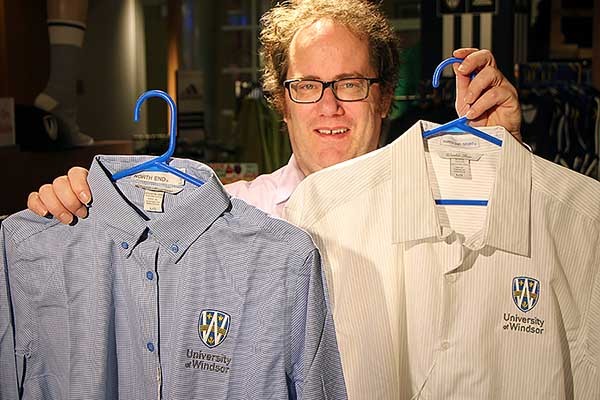 Martin Deck holding shirts.