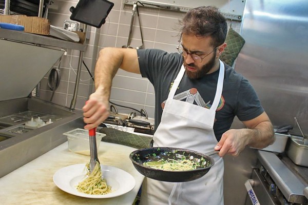 Adam El-Dika plates a dish of pasta