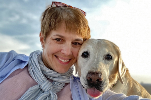 Beth Daly with yellow lab named Grasshopper
