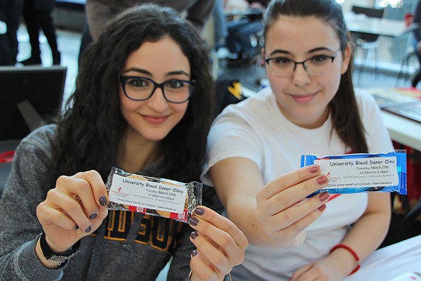 Desiree Mikhael and Milana Milivojevic display packets of cookies